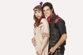 Portrait of young couple in old-fashioned costumes smiling against gray background Royalty Free Stock Photo