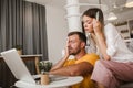 Young couple paying bills online using laptop and credit card Royalty Free Stock Photo