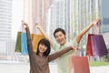 Portrait of young couple posing with shopping bags in hands, Beijing, China Royalty Free Stock Photo
