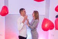 Portrait of young couple with red shape heart air balloons. Valentine`s day celebration concept Royalty Free Stock Photo