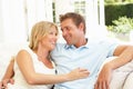 Portrait Of Young Couple Relaxing Together On Sofa Royalty Free Stock Photo