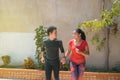 Portrait of a young couple running in the park in the morning. Concept of sport and love. Warm tone Royalty Free Stock Photo