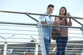 Portrait Of Young Couple Walking To Work Over Bridge