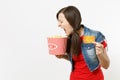 Portrait of young crazy loony brunette woman in casual clothes watching movie film, holding bucket of popcorn and credit Royalty Free Stock Photo