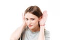 Portrait of a young curious girl trying to hear rumors Royalty Free Stock Photo