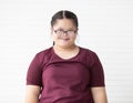 Portrait of a young and cute Asian down syndrome girl wearing eyesglasses and smile face