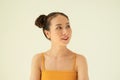 Portrait of young cute Asian girl with two buns against light background Royalty Free Stock Photo