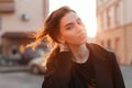 Portrait of a young cute attractive woman with a stylish hairstyle with beautiful eyes with sexy lips in fashionable black clothes Royalty Free Stock Photo