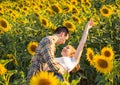 Portrait of a young cute couple dancing in a sunflower field Royalty Free Stock Photo
