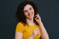 Portrait of young cute emotional caucasian female on grey background.