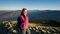 Portrait of young cute female backpacker talking cell phone Royalty Free Stock Photo