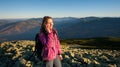 Portrait of young cute female backpacker talking cell phone Royalty Free Stock Photo