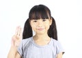 Portrait of young cute girl posting with thtee fingers.