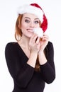 Portrait of a young cute red-haired girl in a Christmas hat Royalty Free Stock Photo