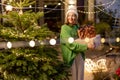 Woman with gift boxes at New Year& x27;s decorated backyard