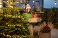 Woman with gift boxes at New Year& x27;s decorated backyard