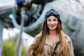 Portrait of a young cute woman pilot in a helmet and pilot suit Royalty Free Stock Photo