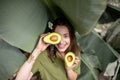 Woman with avocado in banana leaves Royalty Free Stock Photo