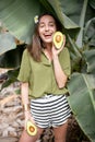 Woman with avocado in banana leaves Royalty Free Stock Photo