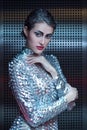 Portrait of young cyber woman in silver futuristic costume with bright makeup.