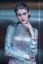 Portrait of young cyber woman in silver futuristic costume with bright makeup.