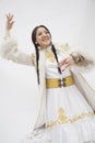 Portrait of young dancing woman with braids in traditional clothing from Kazakhstan, studio shot Royalty Free Stock Photo