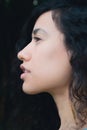 A young woman against black background profile portrait Royalty Free Stock Photo