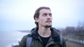 Portrait of young depressed male on a winter beach break