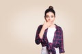 Portrait of young desperate woman in casual style amd bun hairstyle looking surprised, with mouth wide open and hands.