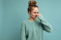 Portrait of young dissatisfied beautiful blonde woman with sincere emotions wearing casual blue pullover isolated on
