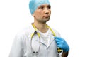 Portrait of a young doctor in a white coat on a black background. A doctor in blue gloves and with a medical stethoscope around Royalty Free Stock Photo