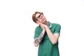 portrait of a young dreaming man with red hair dressed in a green t-shirt Royalty Free Stock Photo