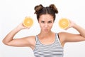 Portrait of a young dynamic woman with two orange slices