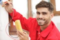 portrait young electrician using multimeter Royalty Free Stock Photo