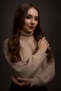 portrait of a young elegant woman with long brown hair, dressed in a knitted sweater Royalty Free Stock Photo