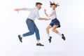 Portrait of young emotive couple, man and woman, dancing retro dance isolated over white studio background. Ralaxation