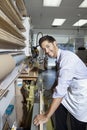 Portrait of a young employee working on wood