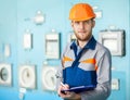 Portrait of young engineer taking notes at control room Royalty Free Stock Photo