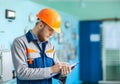 Portrait of young engineer taking notes at control room Royalty Free Stock Photo