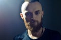 Portrait of young European hipster with fair skin and trendy ginger beard. Fashionable undercut hairstyle and handsome face featur