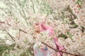 Portrait of young european woman wearing kimono. Asian beauty. Cherry blossoms. Hanami. Sightseeing of Japan concept