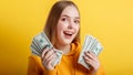 Portrait young excited woman with fan of money banknotes. Emotional happy teenage blonde girl win money cash holding Royalty Free Stock Photo