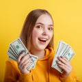 Portrait young excited woman with fan of money banknotes. Square. Emotional happy teenage blonde girl win money cash Royalty Free Stock Photo