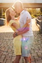 Portrait of a young family couple hugging kissing in the sunlight flecks Royalty Free Stock Photo