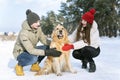 Portrait of young family with..Golden retriever in winter outdoors in forest Royalty Free Stock Photo