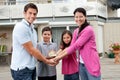 Portrait of young family with a model of house