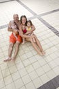 Portrait of young family on pool deck tile Royalty Free Stock Photo