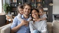 Portrait of young family with small daughters at home