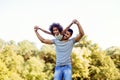 Portrait of young father carrying his daughter on his back Royalty Free Stock Photo