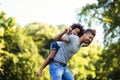 Portrait of young father carrying his daughter on his back Royalty Free Stock Photo